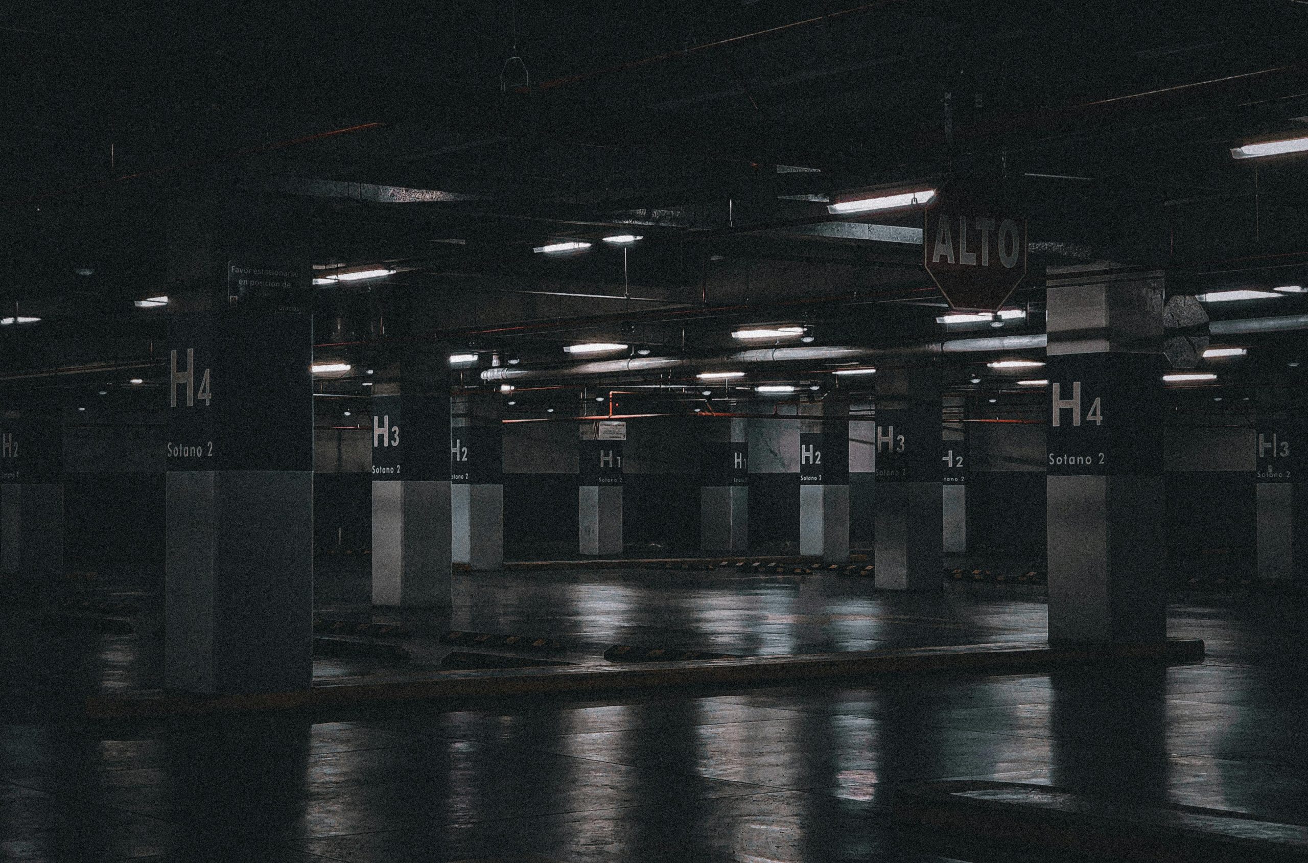 Home Moody view of an empty underground parking lot showcasing industrial urban design in Tegucigalpa, Honduras.